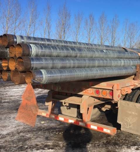 Image of metal pipes stacked on a flatbed truck