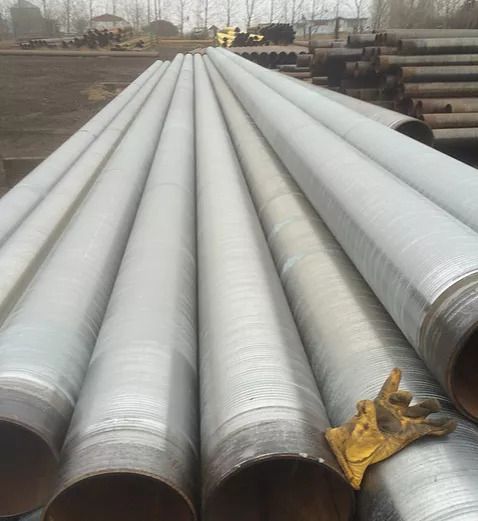 Photo of silver coloured metal pipes stacked on top of each other