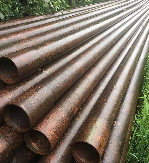 Close up shot of metal pipes stacked on top of each other
